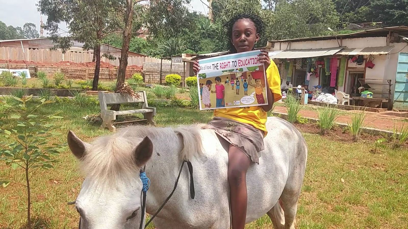A young person holding a poster about the right to education