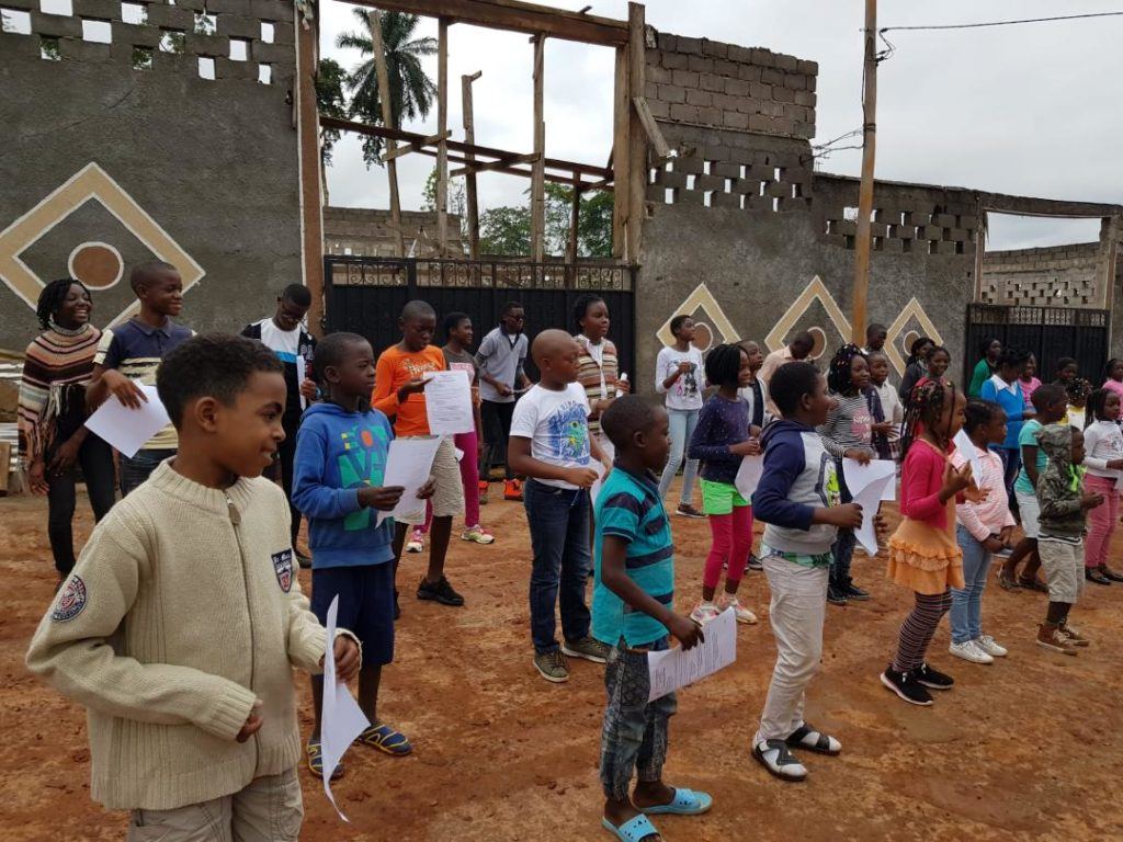 Children and adults taking part in a community activity outdoors