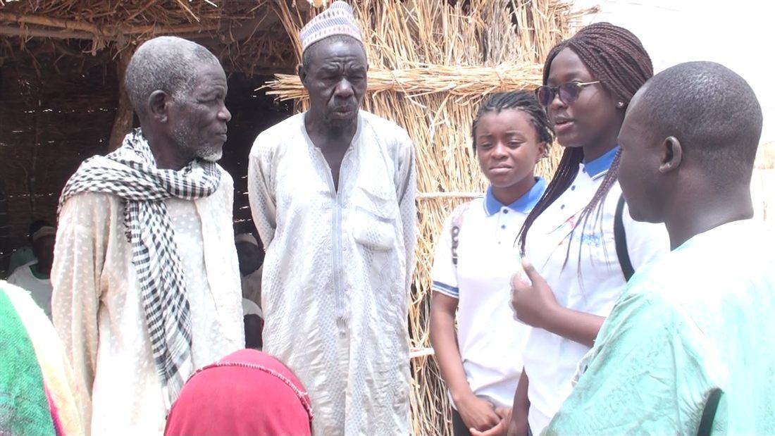 Elders and young people talking in a village